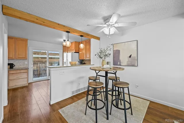 a view of a dining room with furniture and wooden floor