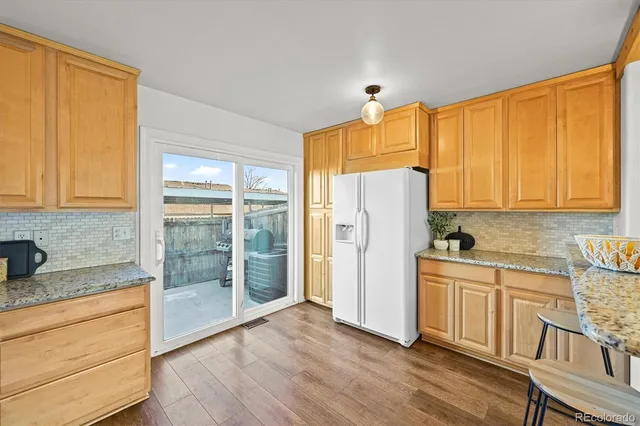 a kitchen with a refrigerator a sink and cabinets