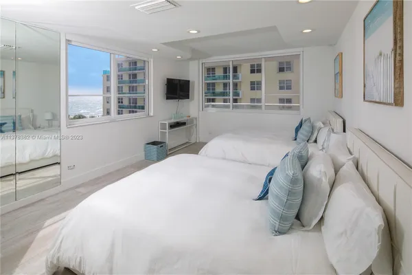 a bedroom with a large bed and a window