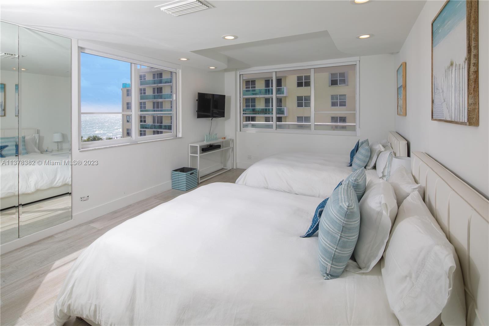 5005 Collins Avenue, Unit 610 Miami Beach, FL 33140 - Photo 13 of 31 a bedroom with a large bed and a window