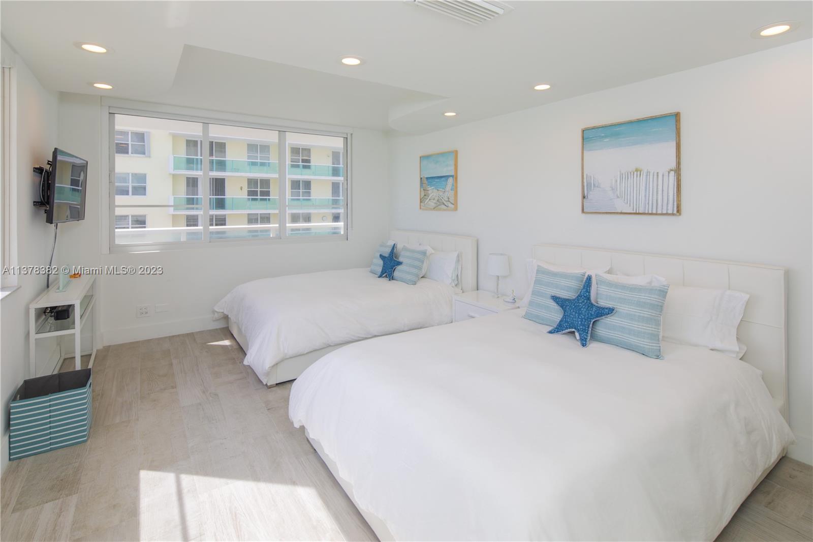 5005 Collins Avenue, Unit 610 Miami Beach, FL 33140 - Photo 14 of 31 a bedroom with a large bed and a window