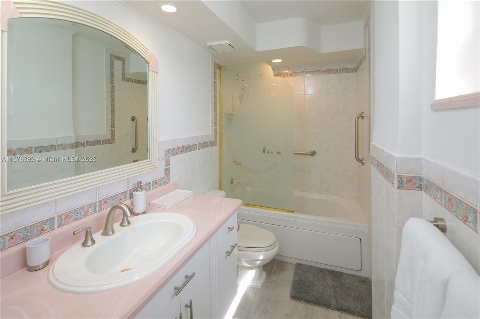 5005 Collins Avenue, Unit 610 Miami Beach, FL 33140 - Photo 16 of 31 a bathroom with a sink a toilet and shower
