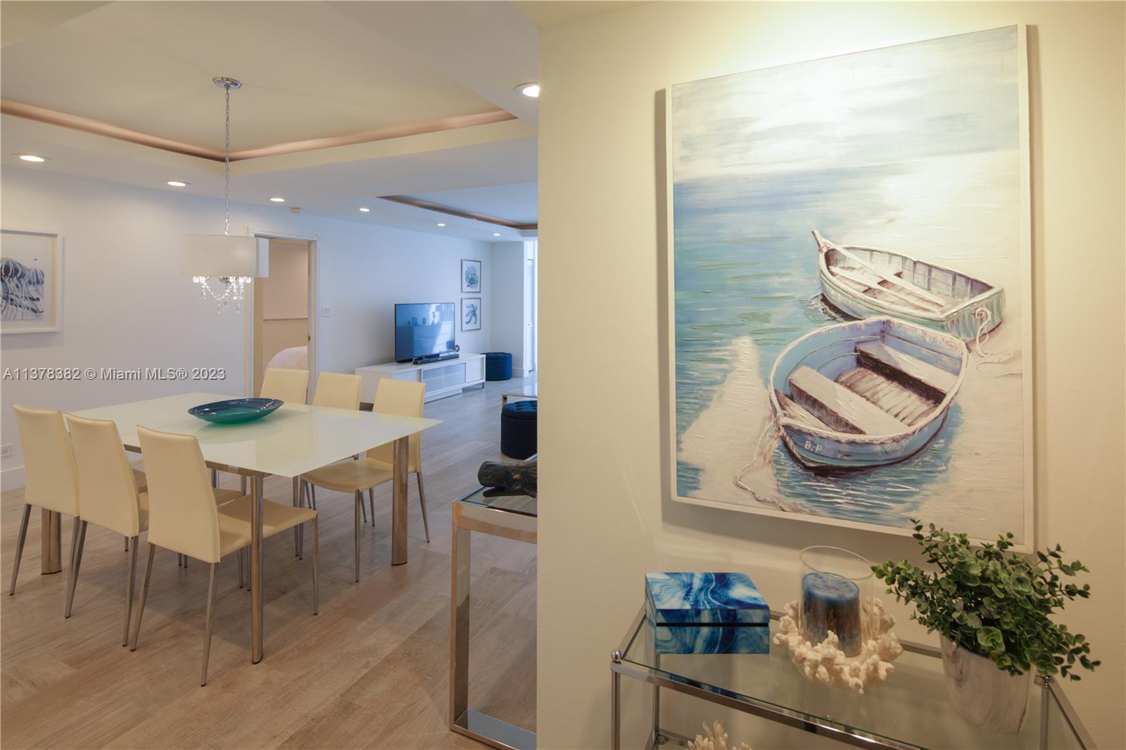 5005 Collins Avenue, Unit 610 Miami Beach, FL 33140 - Photo 3 of 31 a kitchen with a table and chairs in it