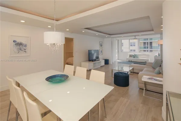 a dining room with stainless steel appliances a table and chairs