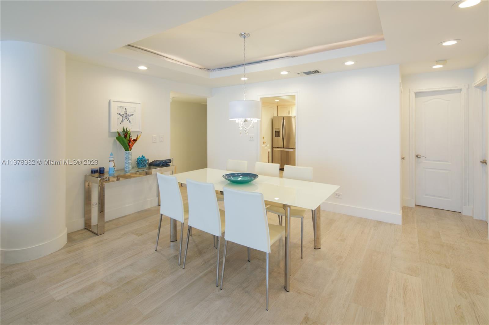 5005 Collins Avenue, Unit 610 Miami Beach, FL 33140 - Photo 5 of 31 a view of a dining room with furniture and wooden floor