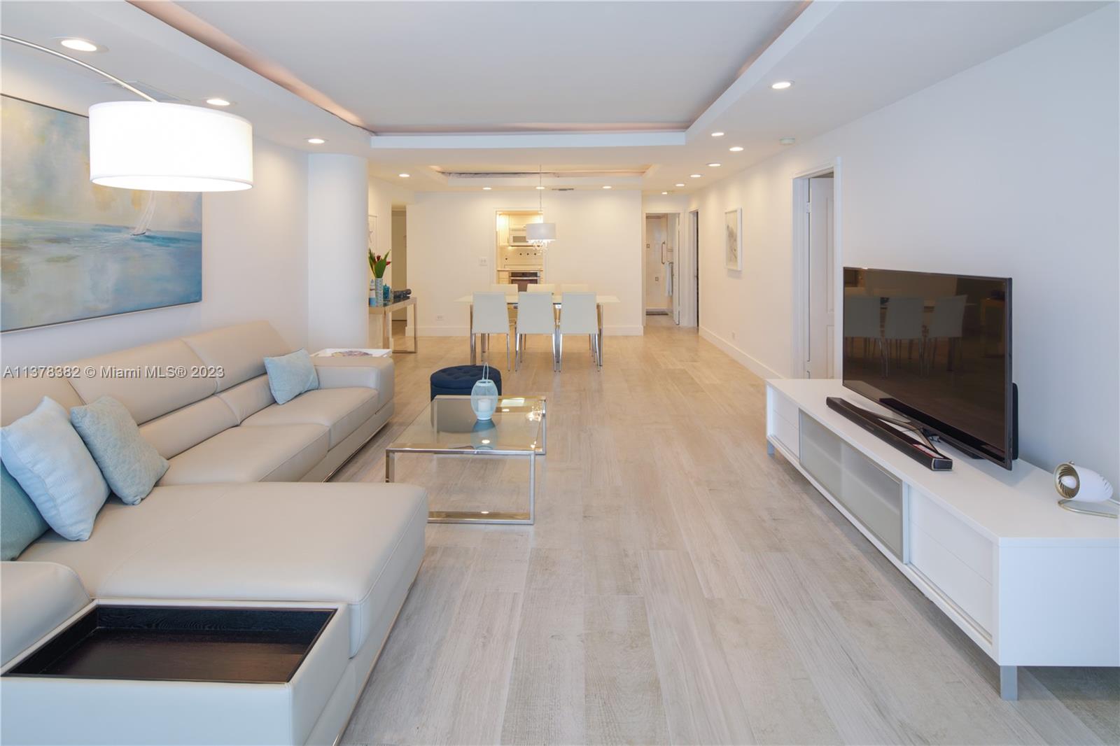 5005 Collins Avenue, Unit 610 Miami Beach, FL 33140 - Photo 6 of 31 a living room with furniture and a flat screen tv