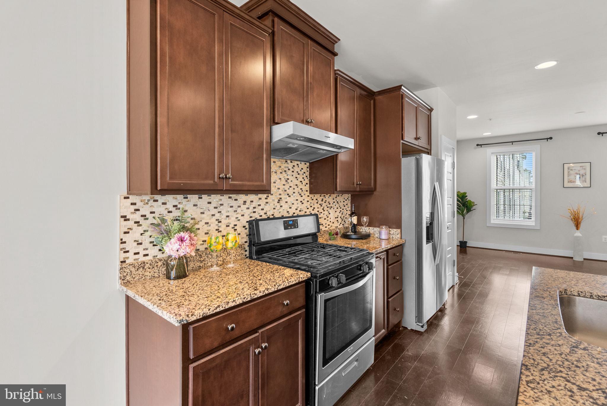 2419 Auden Drive Silver Spring, MD 20906 - Photo 11 of 40 a kitchen with stainless steel appliances granite countertop a sink stove and refrigerator