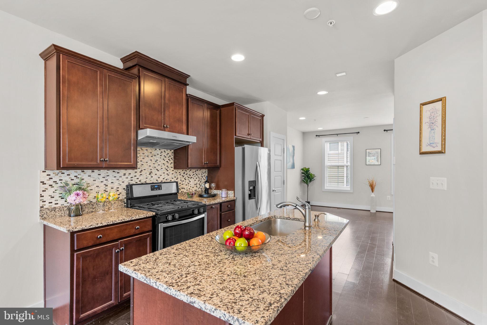 2419 Auden Drive Silver Spring, MD 20906 - Photo 12 of 40 a kitchen with stainless steel appliances granite countertop a sink stove and refrigerator