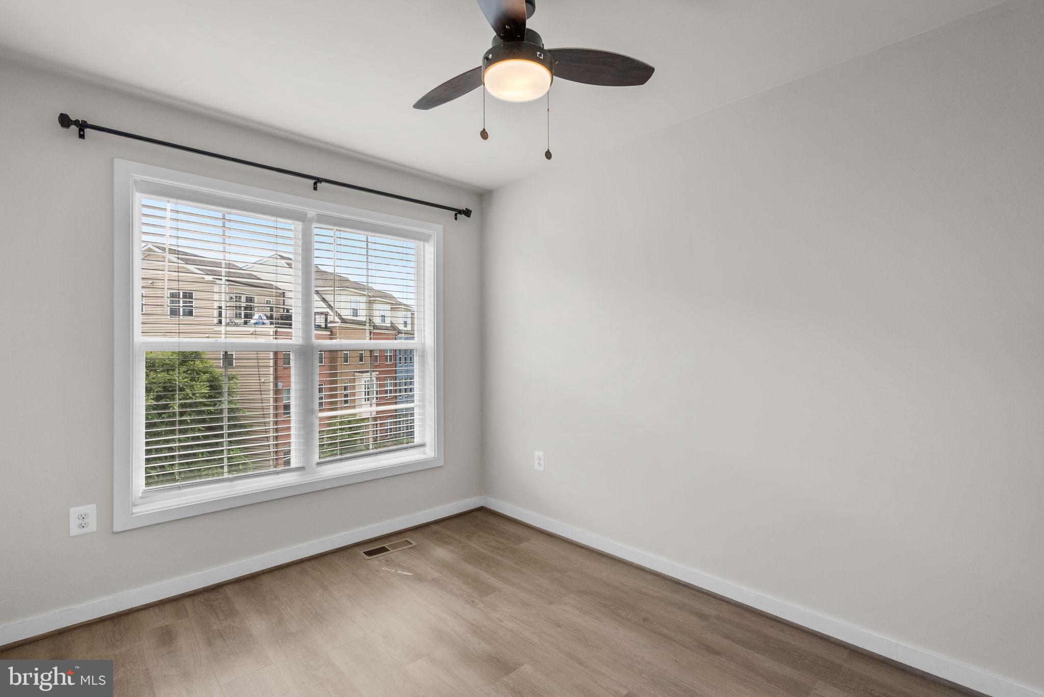 2419 Auden Drive Silver Spring, MD 20906 - Photo 23 of 40 a view of an empty room with window and chandelier fan