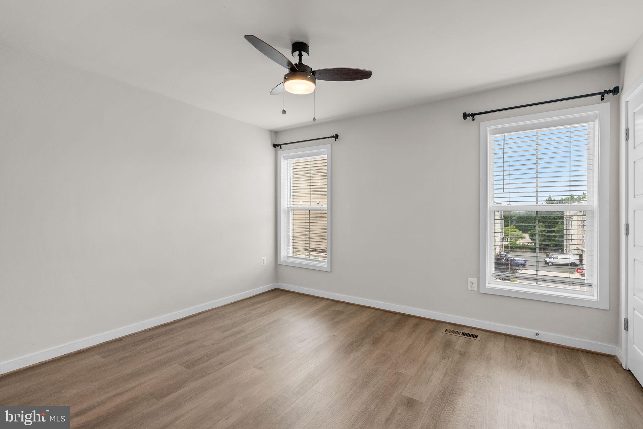 2419 Auden Drive Silver Spring, MD 20906 - Photo 27 of 40 an empty room with wooden floor fan and windows
