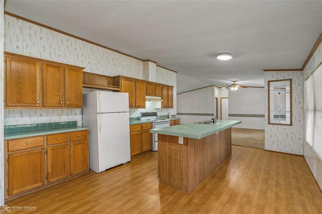 1230 Chipper Lane Keithville, LA 71047 - Photo 17 of 27 a kitchen that has a lot of white cabinets and stainless steel appliances