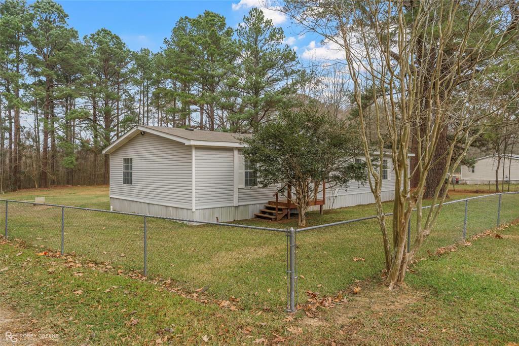 1230 Chipper Lane Keithville, LA 71047 - Photo 2 of 27 a view of a backyard with large trees
