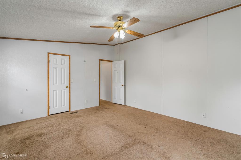 1230 Chipper Lane Keithville, LA 71047 - Photo 21 of 27 a view of an empty room with a chandelier fan
