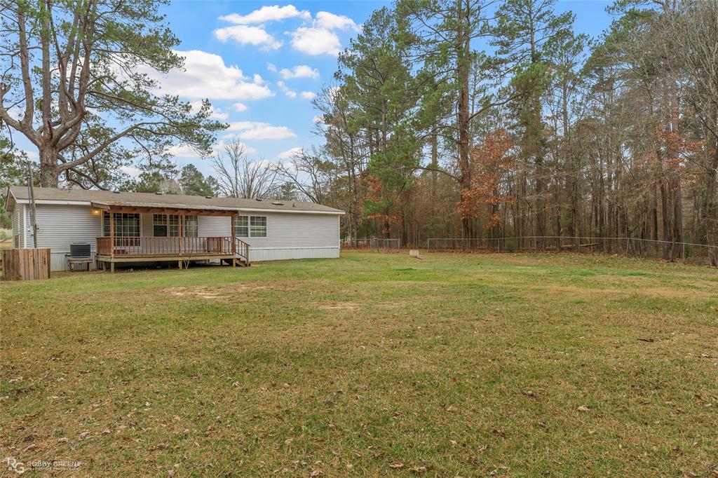 1230 Chipper Lane Keithville, LA 71047 - Photo 6 of 27 a view of a house with a backyard