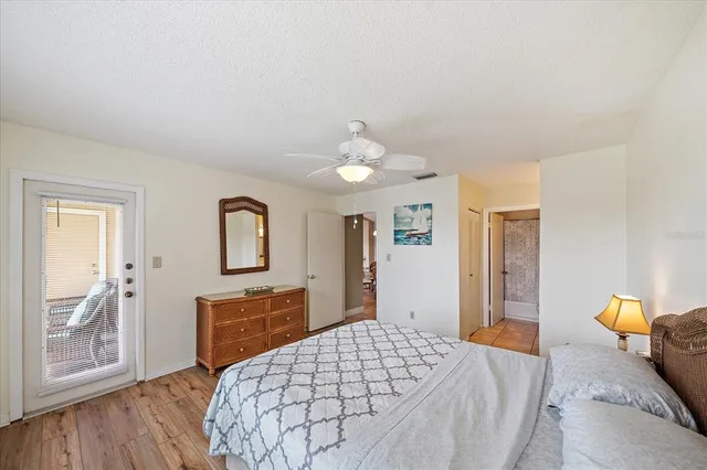 a bedroom with a bed and a dresser with mirror