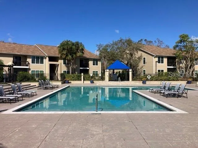 a view of a house with swimming pool and sitting area