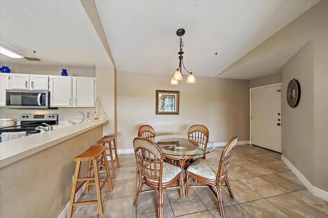 a kitchen with stainless steel appliances granite countertop a sink and a refrigerator