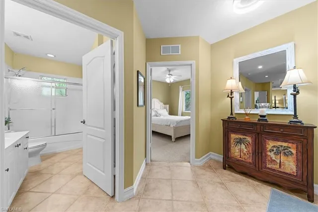 a dining room with furniture a chandelier and window