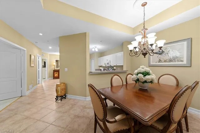 a living room with furniture a floor to ceiling window and a flat screen tv