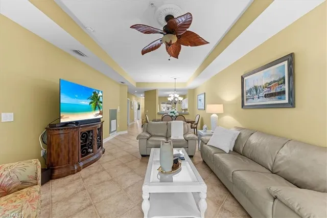 a kitchen with white cabinets and sink