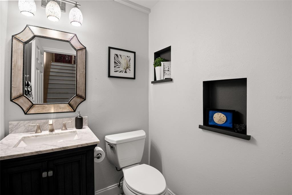 529 Sandy Hook Road Treasure Island, FL 33706 - Photo 23 of 55 a bathroom with a toilet a sink and mirror