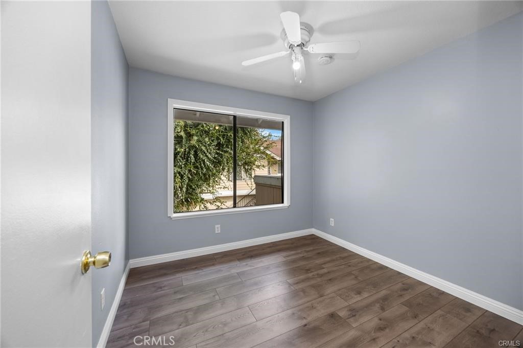 12640 Briarglen Loop, Unit F Stanton, CA 90680 - Photo 18 of 25 an empty room with a window and a ceiling fan