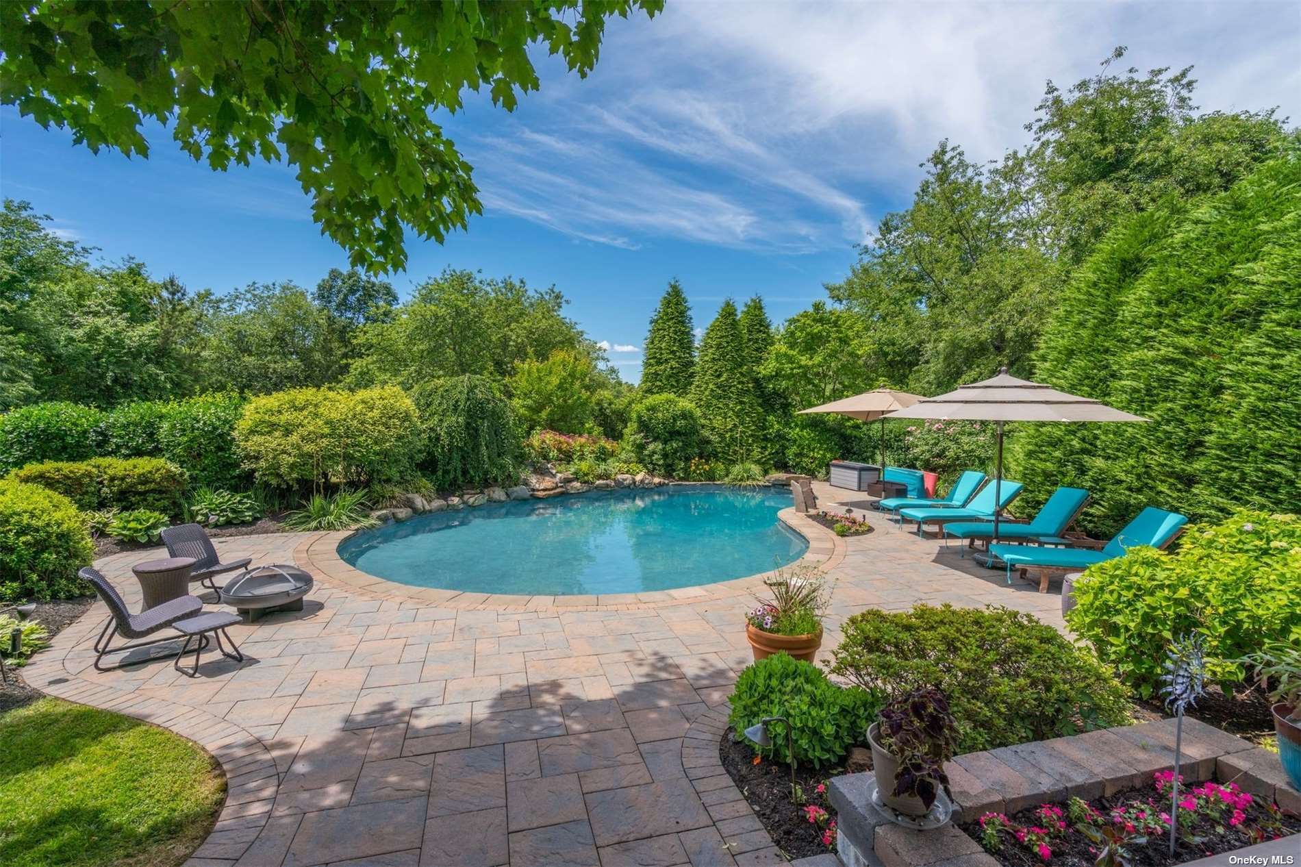 a view of a backyard with swimming pool and furniture