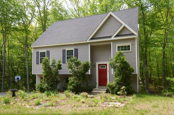 124 Podunk Road Sturbridge, MA 01566 - Photo 18 of 18 a front view of a house with a yard and trees