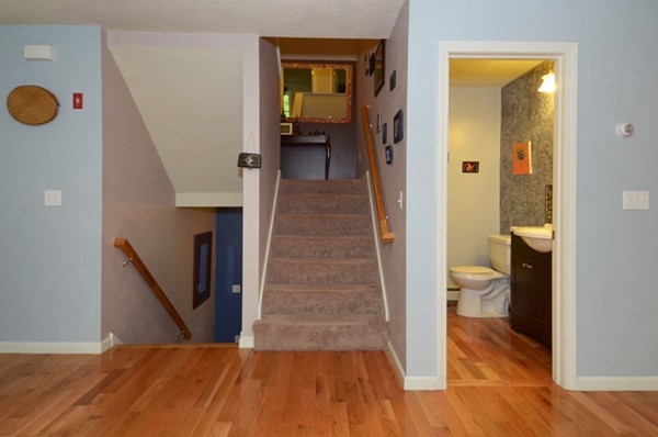 124 Podunk Road Sturbridge, MA 01566 - Photo 7 of 18 a view of a hallway view with wooden floor and staircase