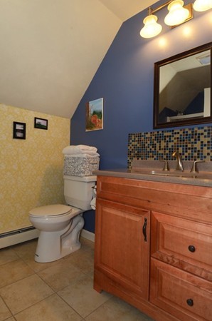 124 Podunk Road Sturbridge, MA 01566 - Photo 8 of 18 a bathroom with a toilet a sink and a mirror
