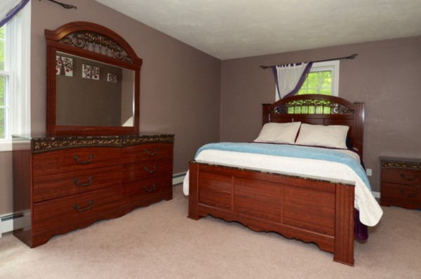 124 Podunk Road Sturbridge, MA 01566 - Photo 9 of 18 a bedroom with a bed and a flat tv screen on dresser