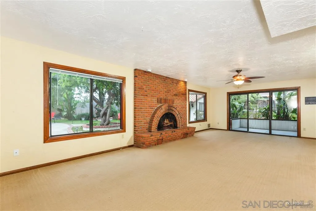 1156 Wild Canary Lane Encinitas, CA 92024 - Photo 11 of 20 an empty room with furniture a fireplace and windows