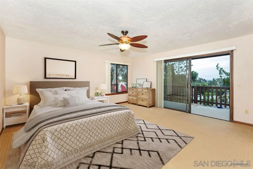 1156 Wild Canary Lane Encinitas, CA 92024 - Photo 12 of 20 a bedroom with a bed and glass window