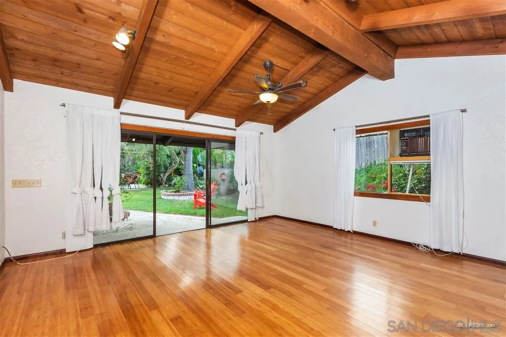1156 Wild Canary Lane Encinitas, CA 92024 - Photo 19 of 20 a view of an empty room with wooden floor and fan