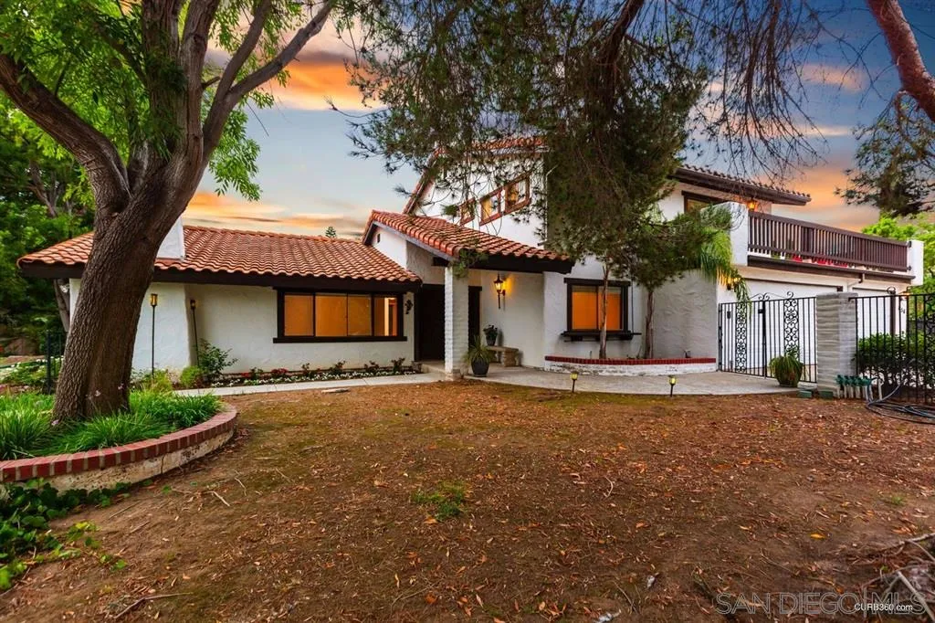 1156 Wild Canary Lane Encinitas, CA 92024 - Photo 3 of 20 a front view of a house with a garden and tree