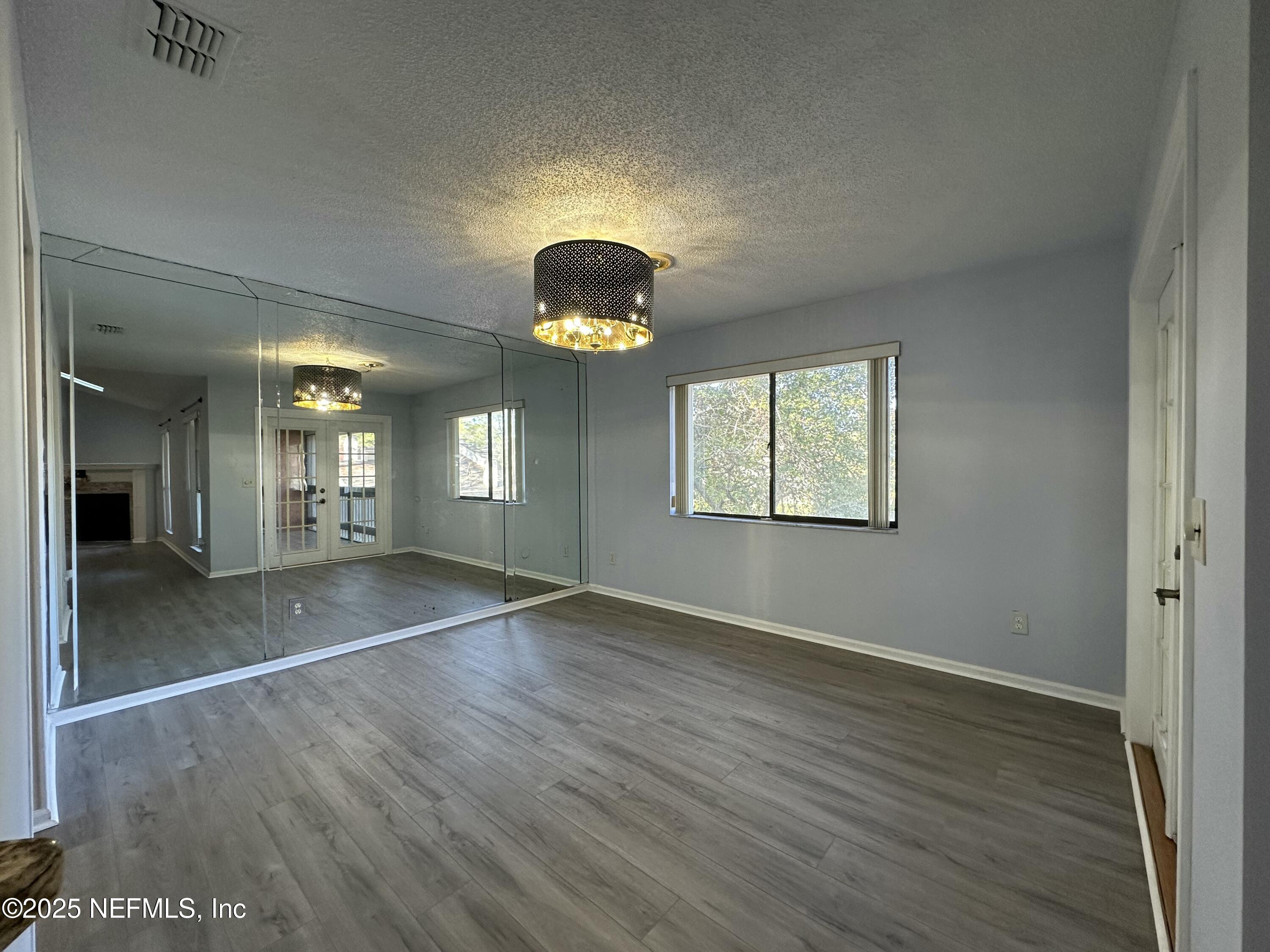 3801 Crown Point Road, Unit 3082 Jacksonville, FL 32257 - Photo 20 of 41 an empty room with wooden floor and windows