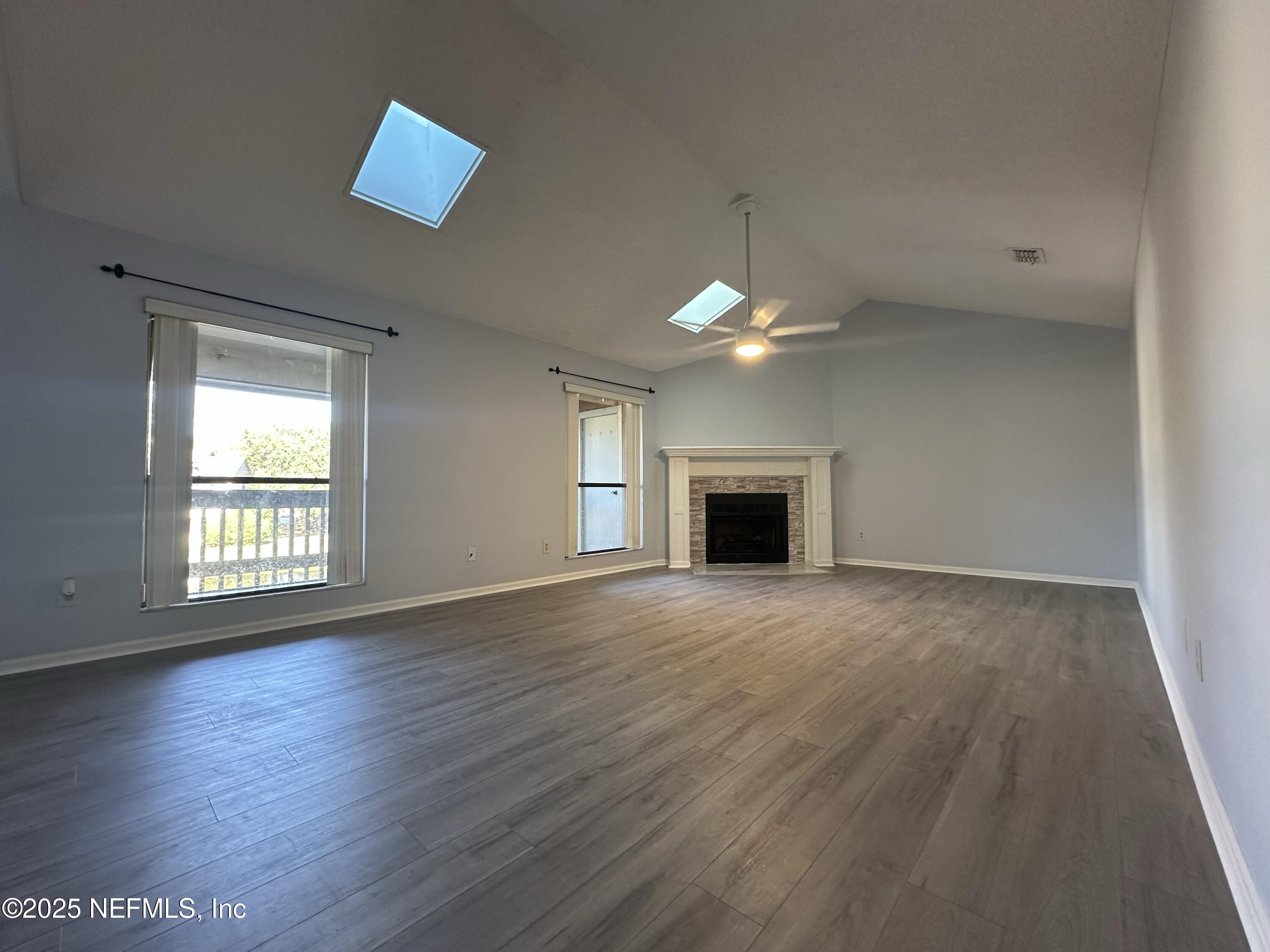 3801 Crown Point Road, Unit 3082 Jacksonville, FL 32257 - Photo 2 of 41 an empty room with wooden floor and windows