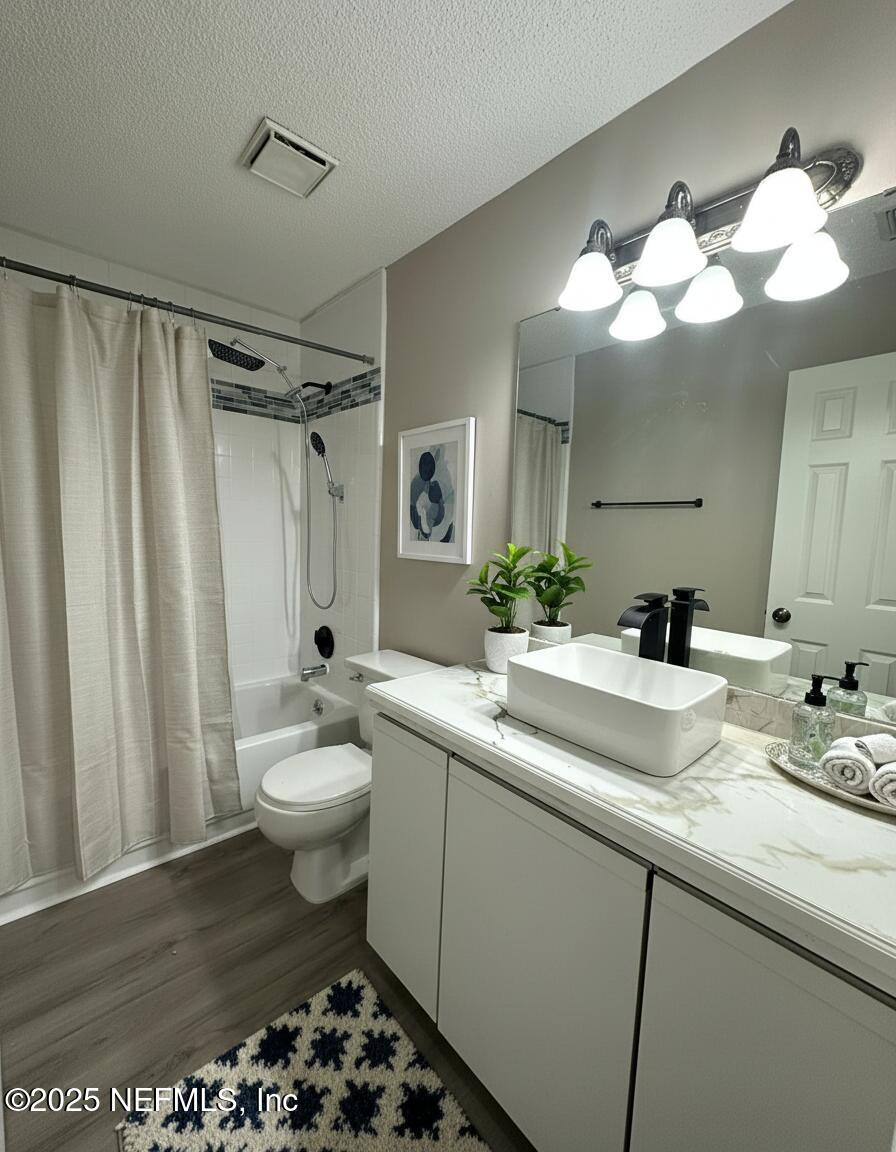 3801 Crown Point Road, Unit 3082 Jacksonville, FL 32257 - Photo 25 of 41 a bathroom with a sink a toilet and a mirror