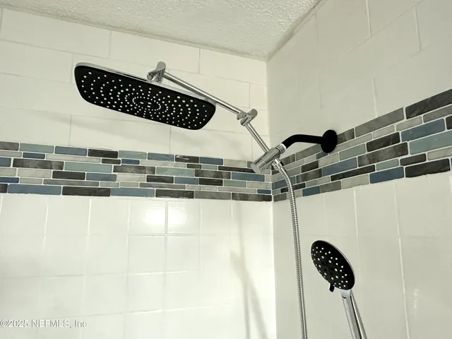 a white toilet sitting next to a bath tub