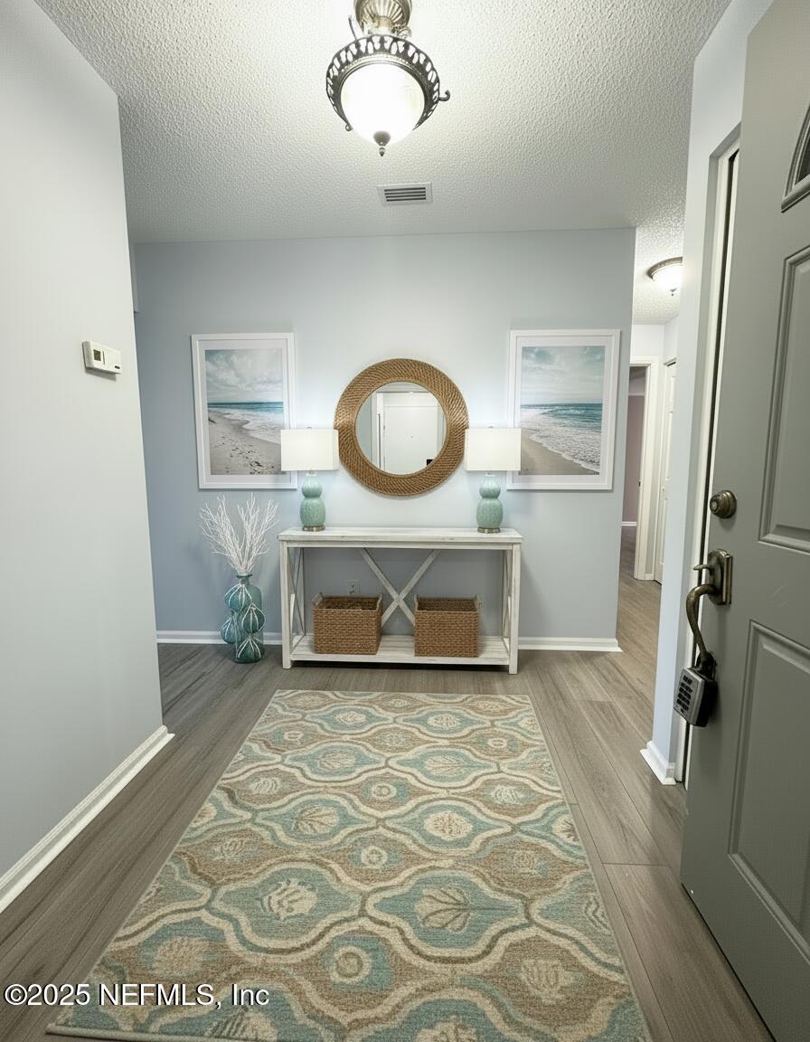 3801 Crown Point Road, Unit 3082 Jacksonville, FL 32257 - Photo 6 of 41 a living room with a mirror and a rug