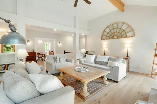 a living room with furniture a rug and a chandelier