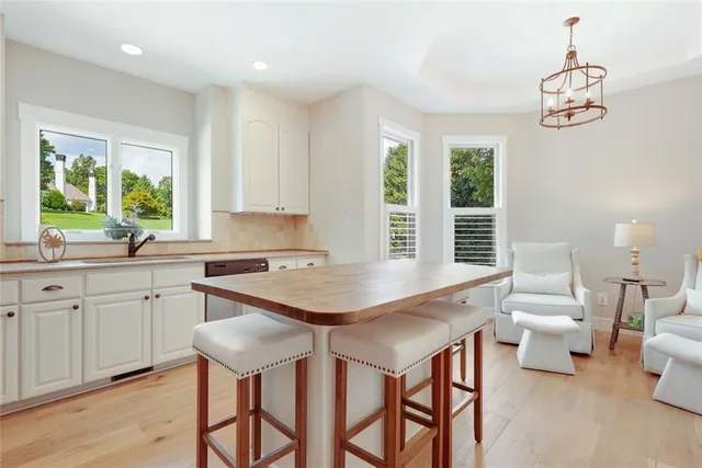 a room with a table chairs and entryway