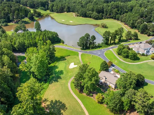 an aerial view of a house with a garden and swimming pool
