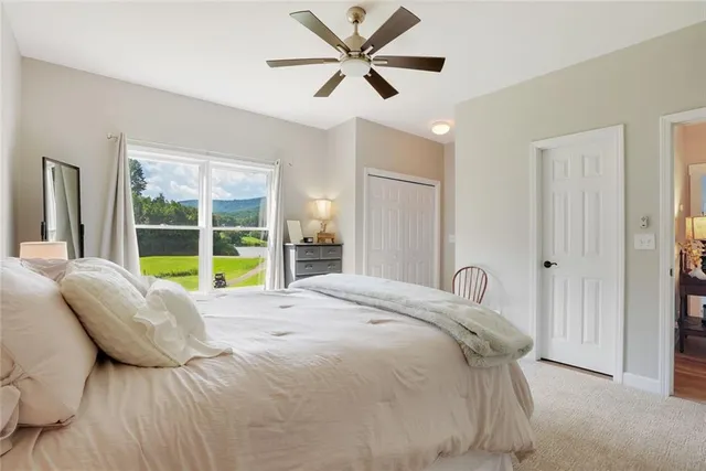 a bed sitting in a bedroom next to a window