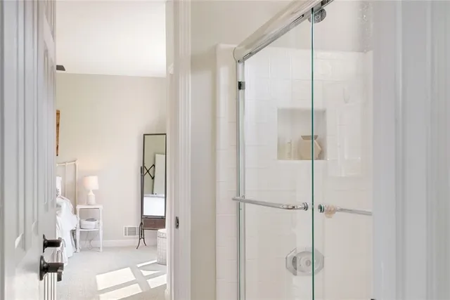 a bathroom with a glass shower door