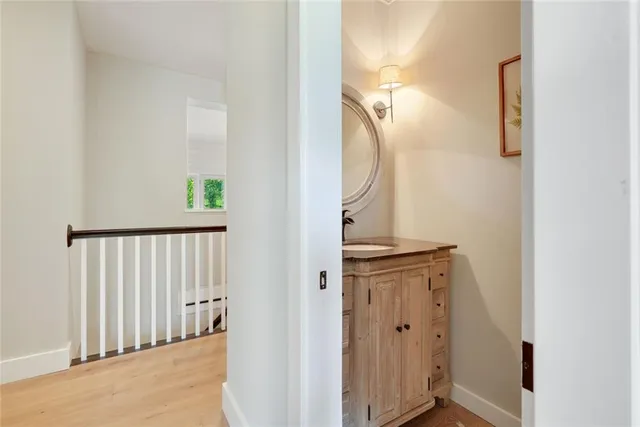 a view of a hallway with wooden floor and entryway