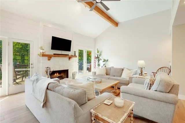 a living room with furniture a fireplace and a flat screen tv