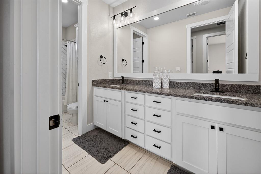 221 Proctor Lane Decatur, TX 76234 - Photo 13 of 30 a bathroom with a granite countertop sink and a mirror