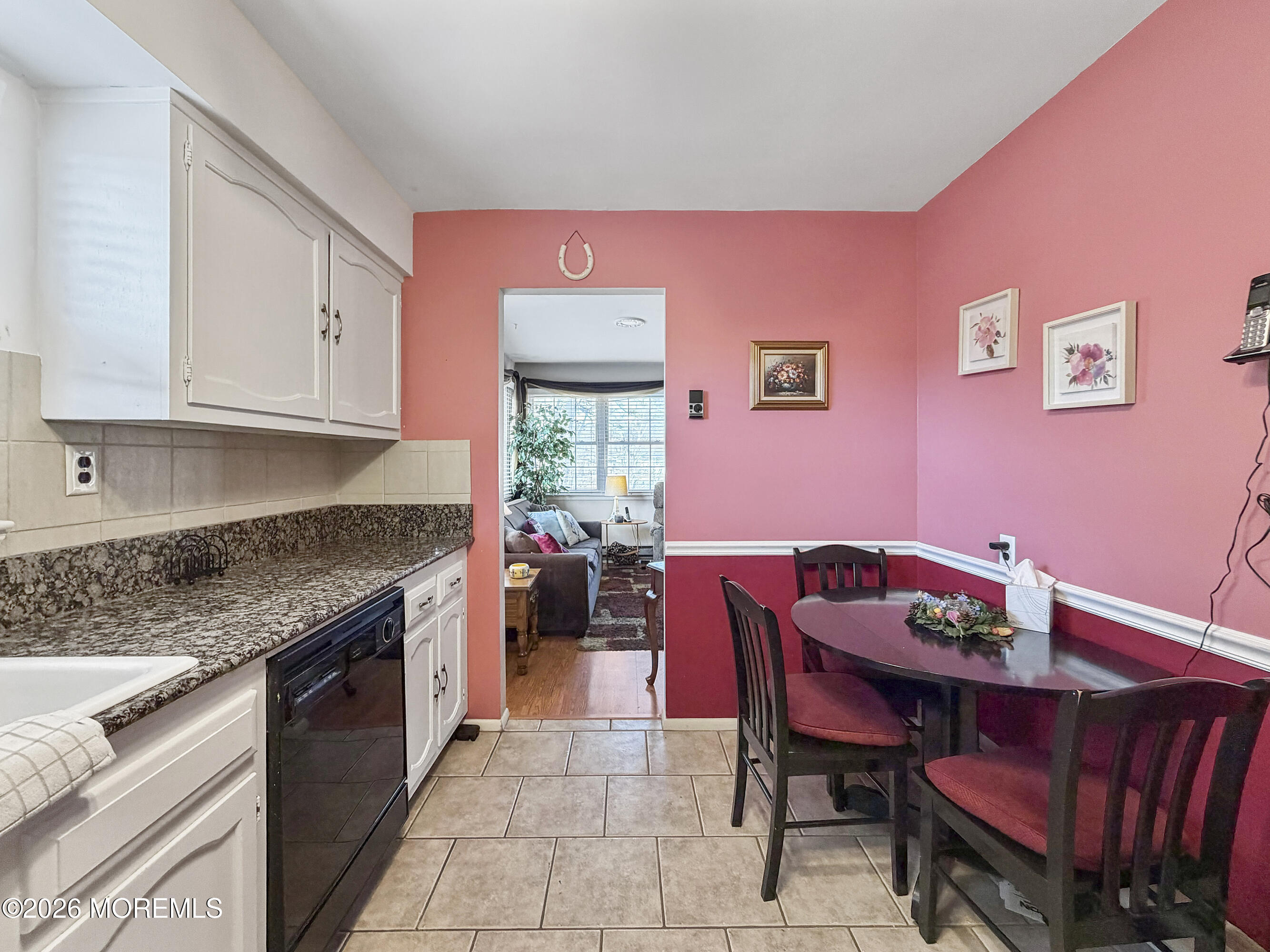 23 Higgins Court Brick, NJ 08724 - Photo 13 of 28 a kitchen with granite countertop a dining table chairs and a refrigerator