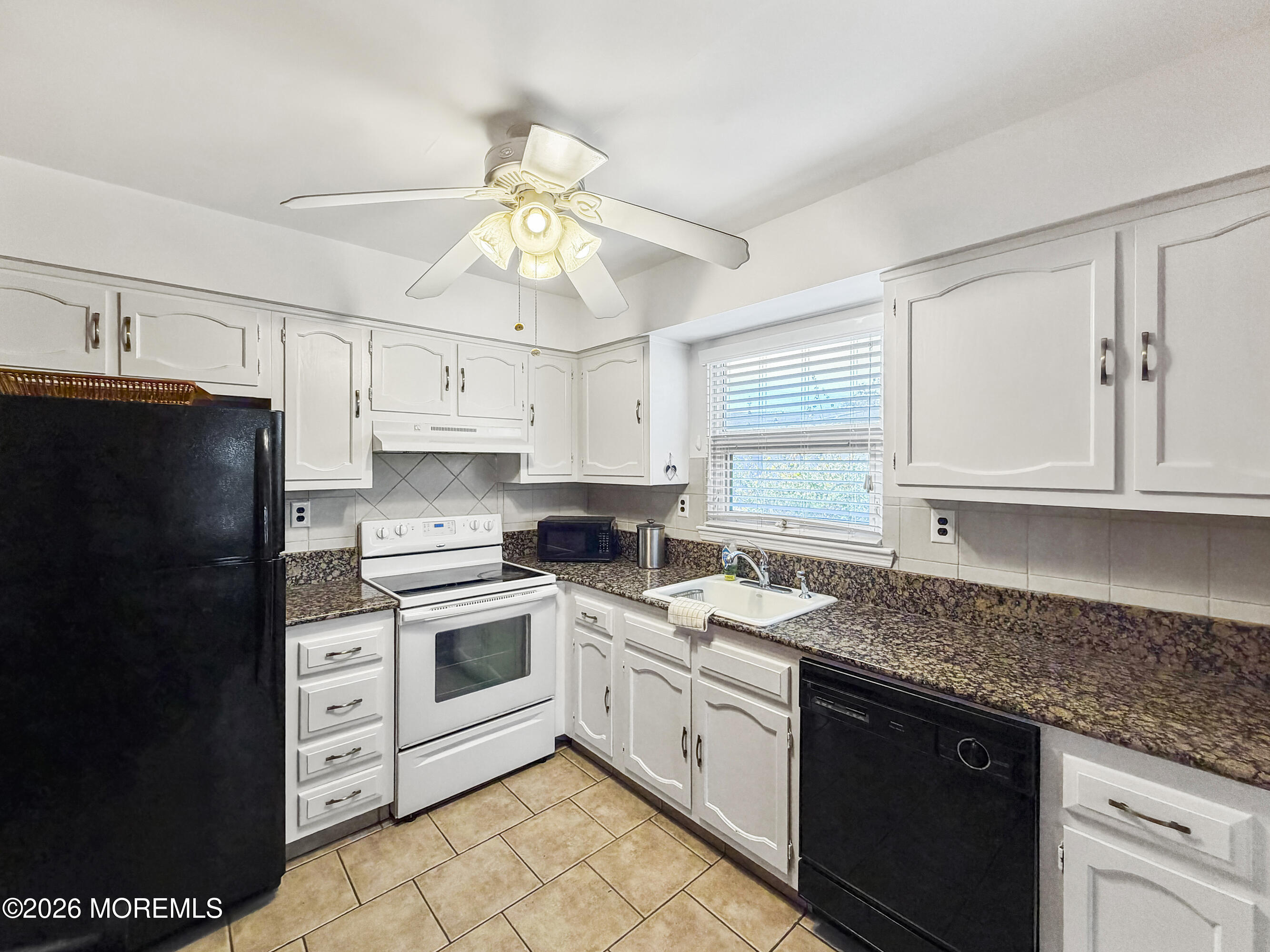 23 Higgins Court Brick, NJ 08724 - Photo 26 of 28 a kitchen with a sink a stove and refrigerator